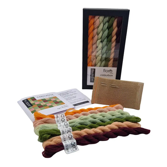 Fru zippe colorbox med garn, stramei, nål og oppskrifter